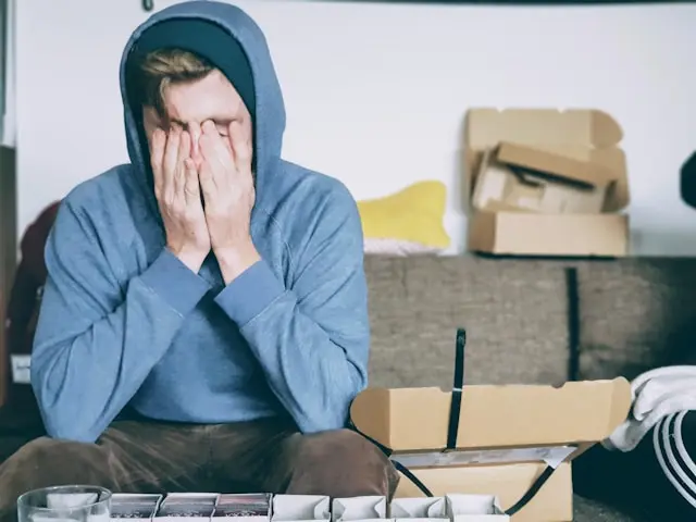 man holding hands on face looking tired during drowsy driving prevention week awareness