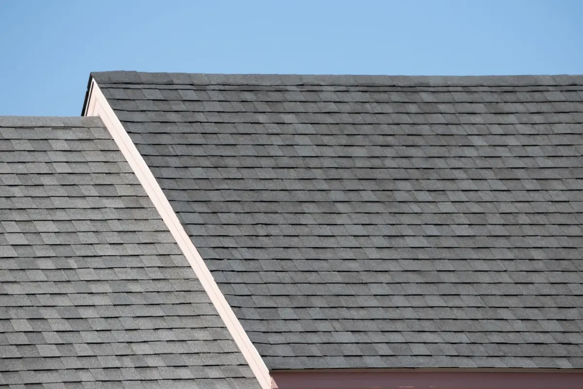 Roof shingles on top of the house against blue sky