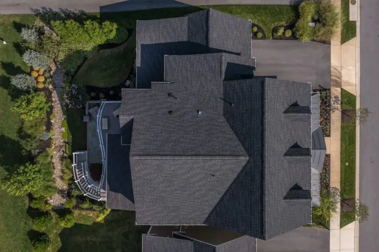Aerial top down view of a complex hip and valley pitched roof with three dormers on a new construction home