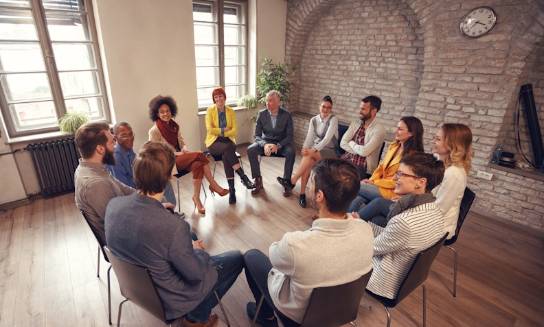 Participants in a group therapy session share their struggles