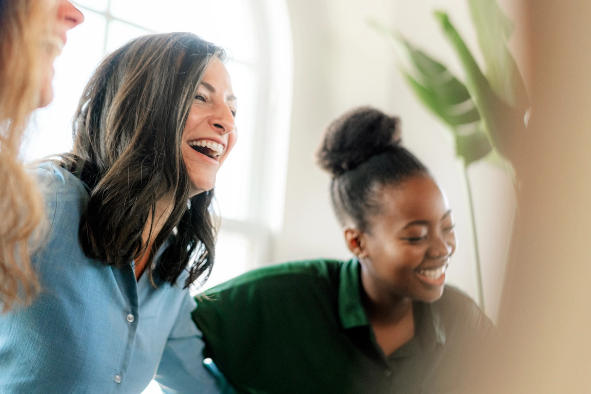 Participants in group therapy laugh as they share a lighter moment