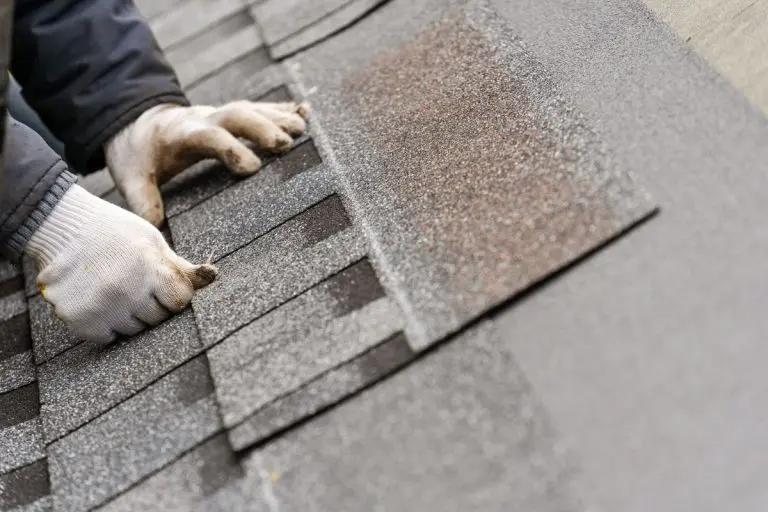 hand repairing shingle, Roseville, Minnesota